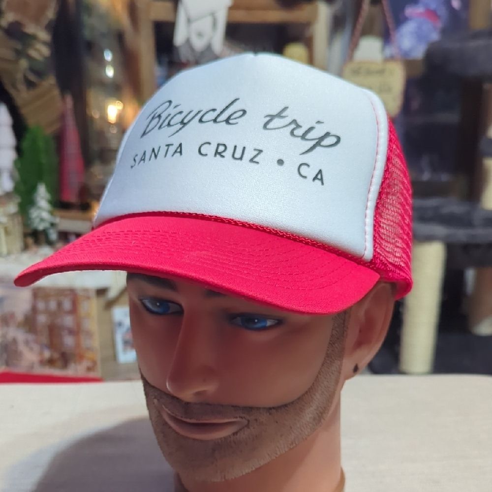 red and white trucker hat featuring text that says "Bicycle trip SANTA CRUZ CA